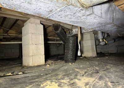 Photo of crawl space in Florence, AL showing standing water in various places and fungus growth & mold. Also shows damaged duct work.
