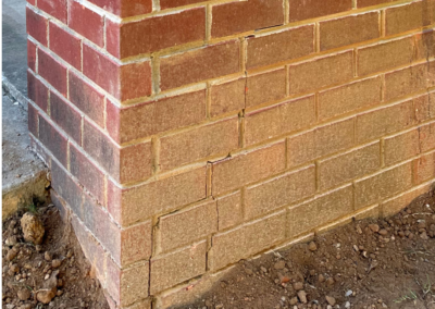 Hairline cracks in brick wall indicating early signs of foundation settlement